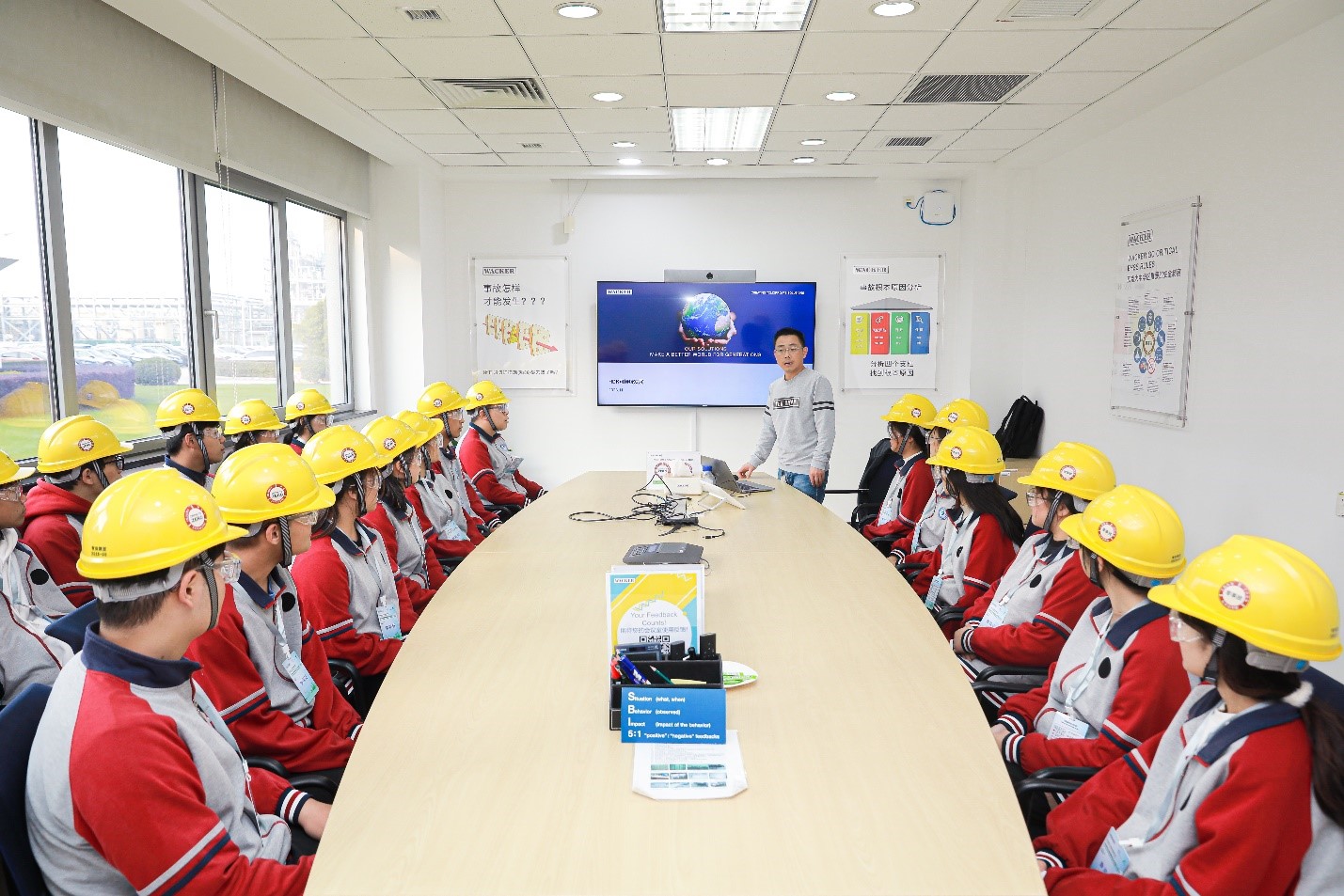 一位张家港生产基地员工向张家港中等专业学校的师生介绍工厂的降碳措施。（图片：瓦克）.jpg